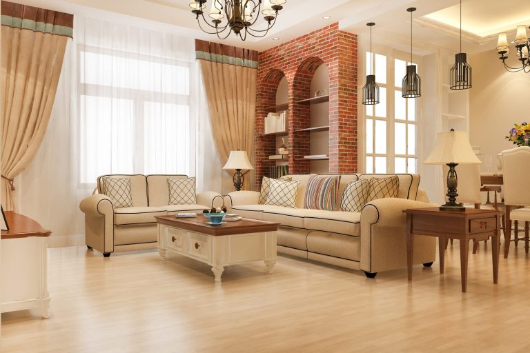 Bright vacation rental living room with sofas and brick shelving